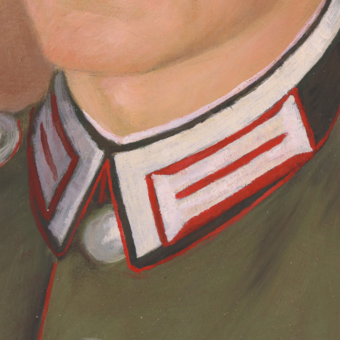 Close-up of a person wearing a green uniform with a red and white collar detail.