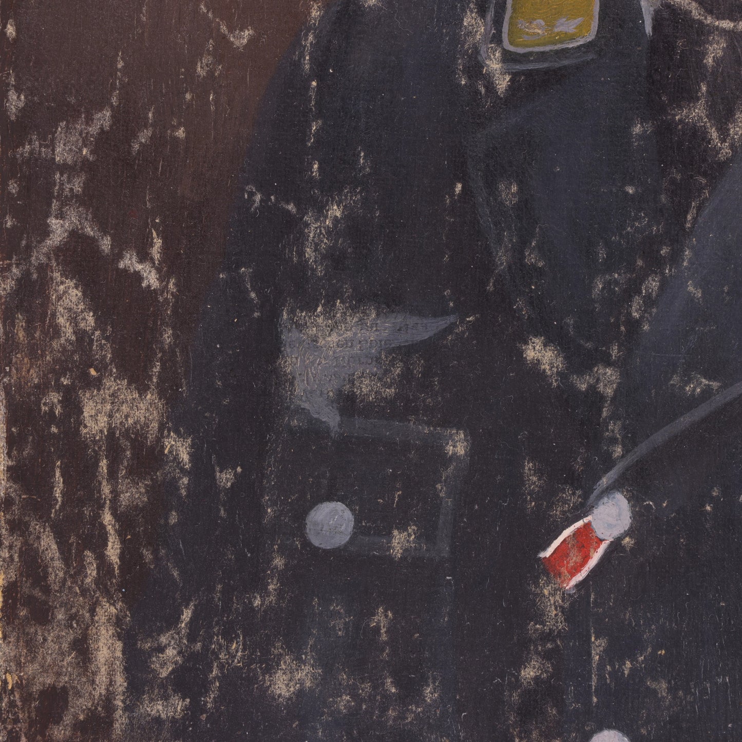 Close-up of a dark fabric with a button and red label on a textured background