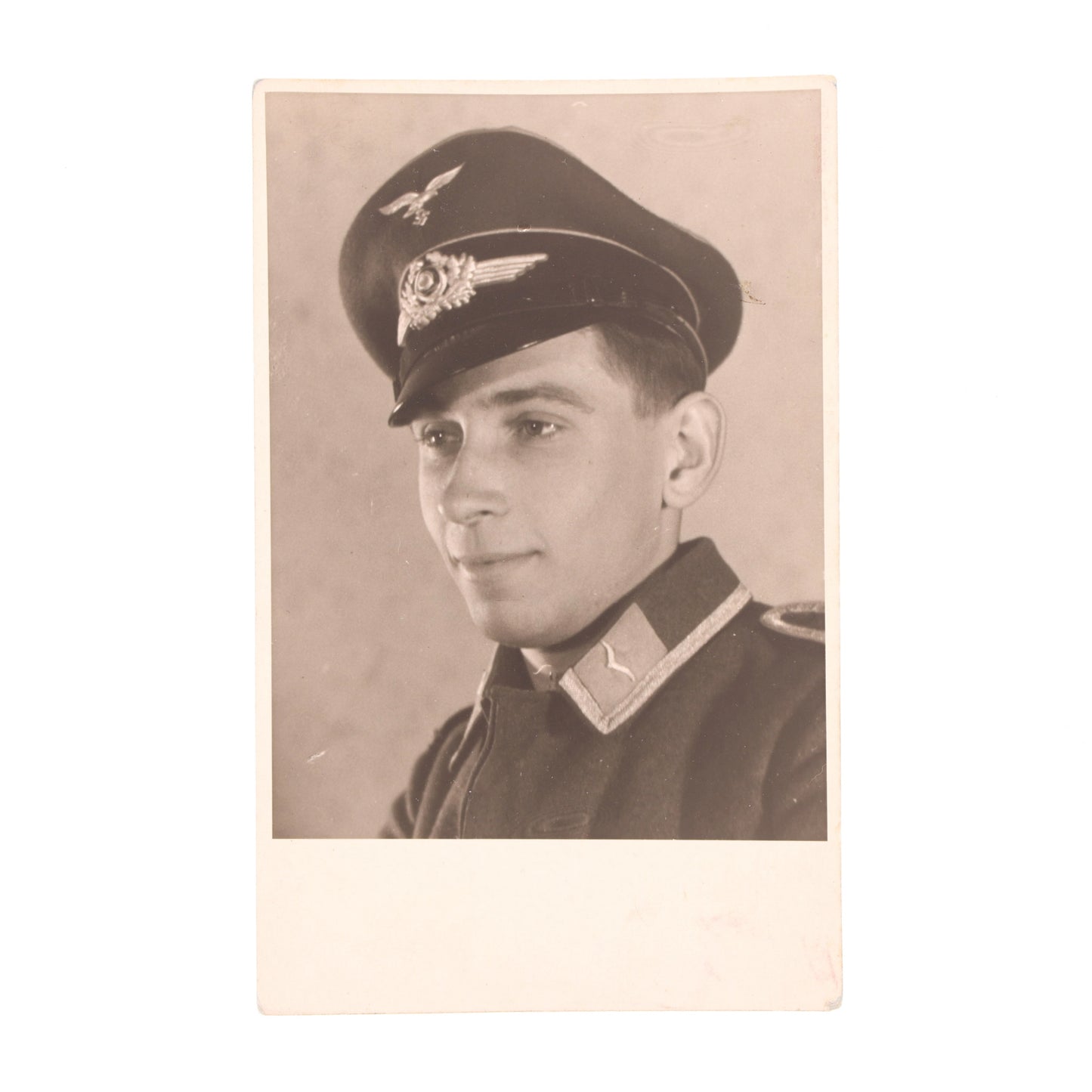 Vintage sepia-toned photograph of a person in military uniform with a cap.