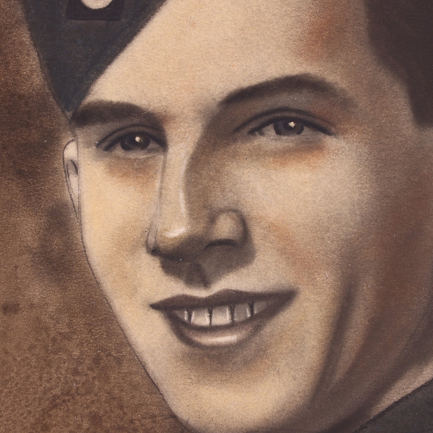 Close-up of a person wearing a cap with a brown background