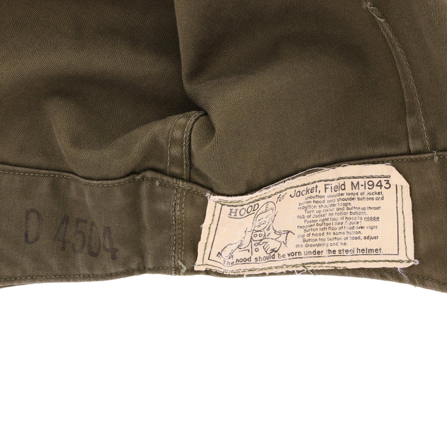 Close-up of a M1943 jacket hood label with text and a logo on a white background