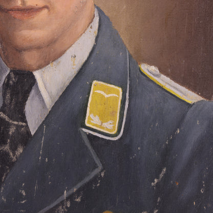 Close-up of a person wearing a dark blue uniform with a yellow patch on a brown background