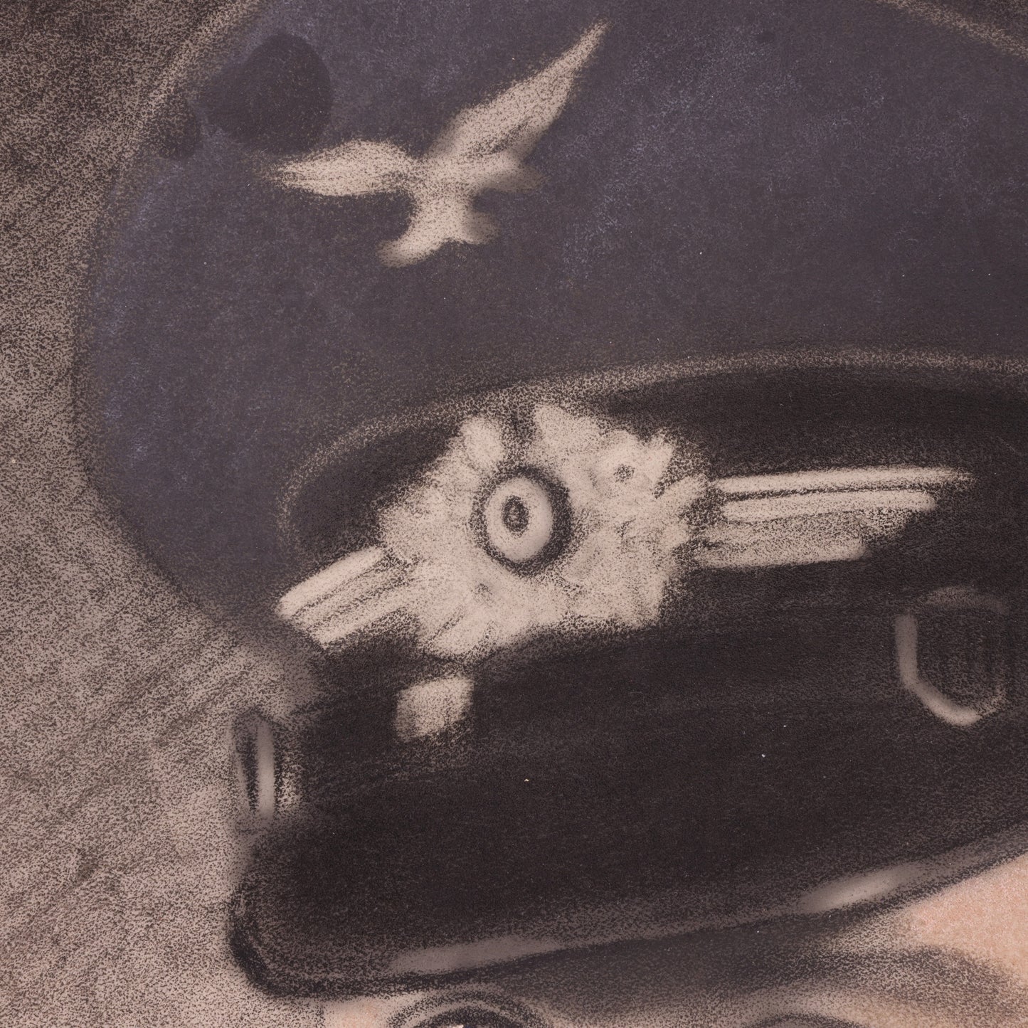 Close-up of a black leather cap visor with a detailed design on a textured surface