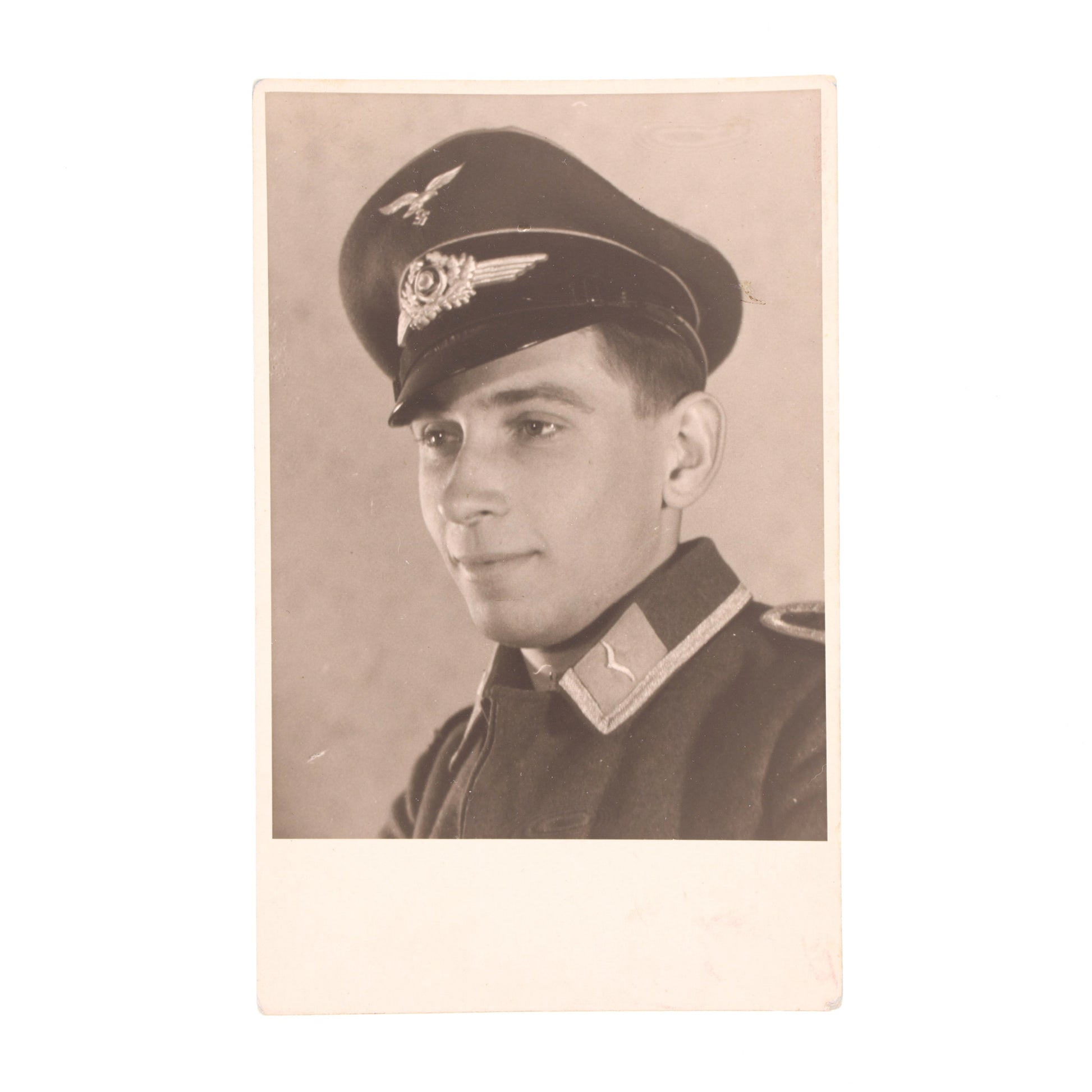 Vintage sepia-toned photograph of a person in military uniform with a cap.