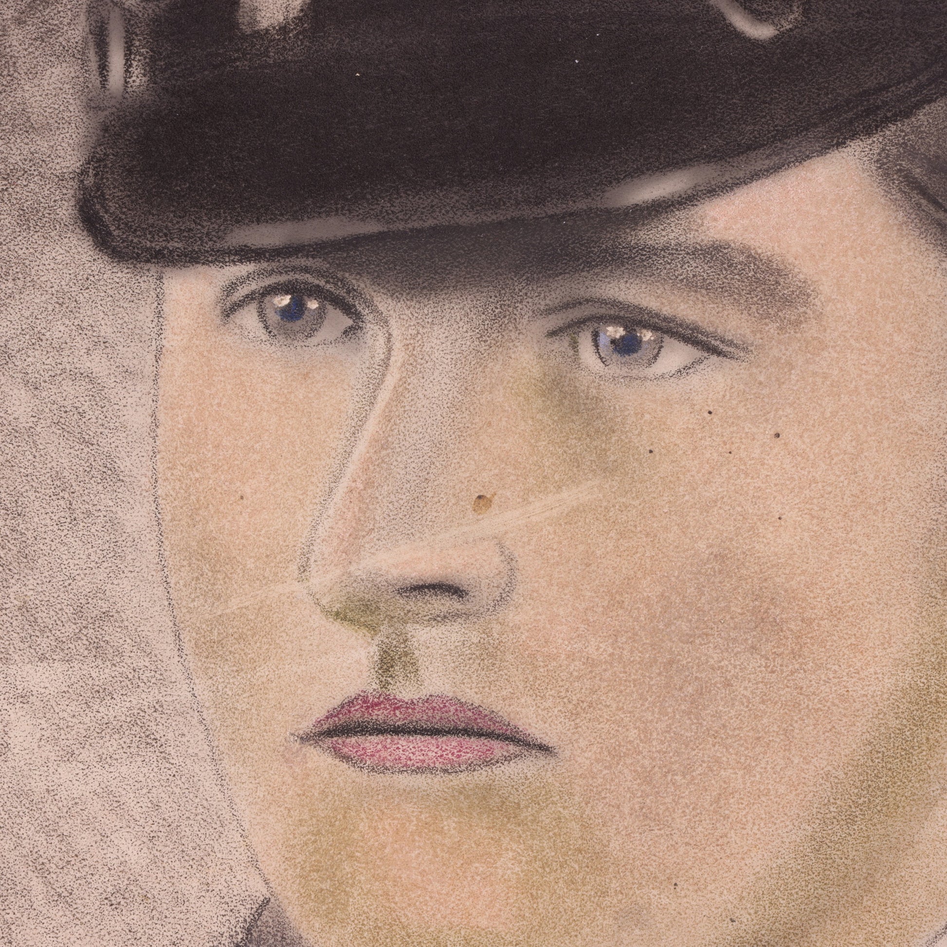 Close-up of a person wearing a cap with a neutral background