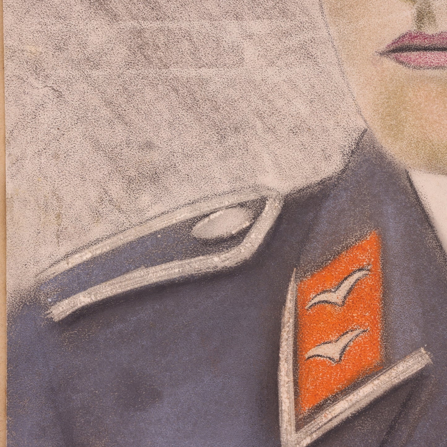 Close-up of a military uniform with a badge featuring two birds on a red background.