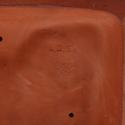 Terracotta sculpture with 'L/D. 56' and a crown interlaced with 'W G'.